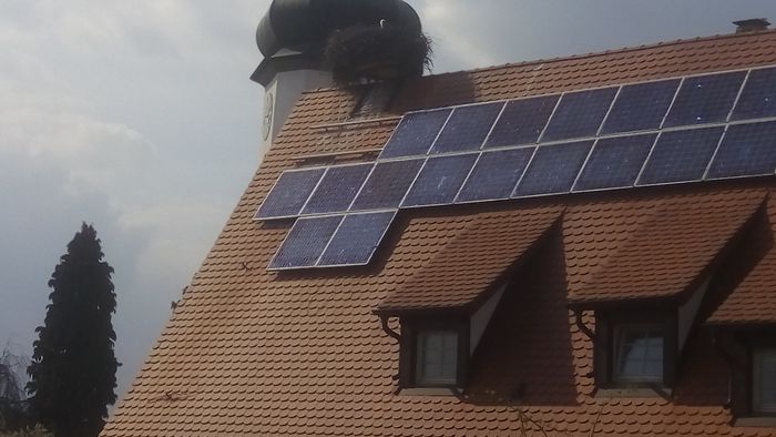 Foto eines Hausdaches, auf dem Solarmodule angebracht sind.